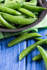 Whole fresh peas in vintage bowl