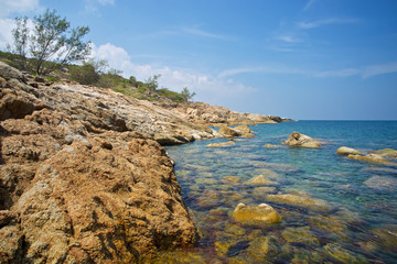 Stone beach with clear water, Phangan island, Thailand