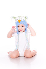 Cute little baby crawling in a owl hat