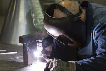 professional welder welding metal parts