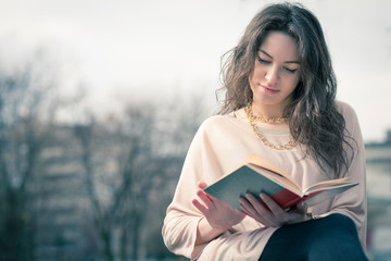 Girl reading a book in park