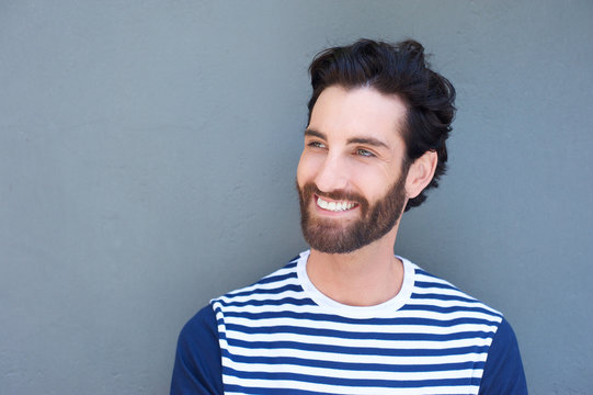 Handsome young man with beard smiling