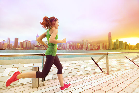 Urban Runner Woman Jogging In Hong Kong At Sunset