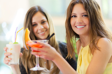 Portrait of two friends drinking a cocktail