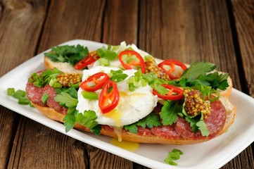 Poached egg sandwiches with chili, scallion and salami