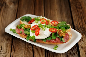 Poached egg sandwiches with chili, scallion and salami