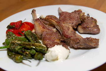 lamb racks with pimentos de padron and tomatos