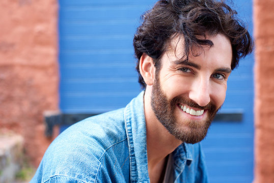 Trendy modern man with beard smiling