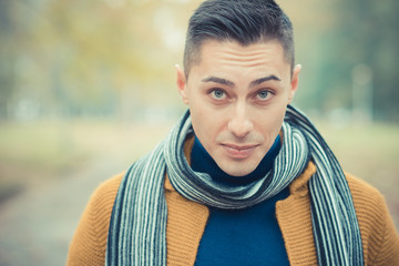 young handsome caucasian man in autumn park