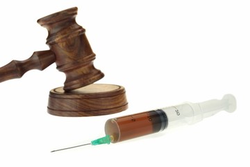Judges Gavel and Syringe With Brown Liquid Isolated