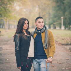 young couple in the park during autumn season outdoor