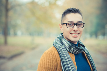 young handsome caucasian man in autumn park