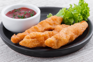 Fried fish fingers with sauce