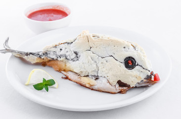 Sea bream in salt crust. Dorada fish
