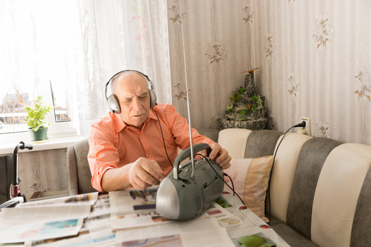 Man with Headset Listening from Cassette Player