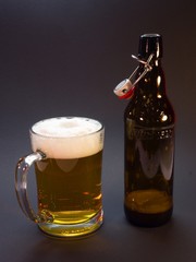 Half liter glass and bottle with traditional cap of czech beer