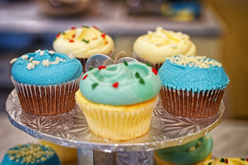 Cupcakes on the round stand at bakery storefront