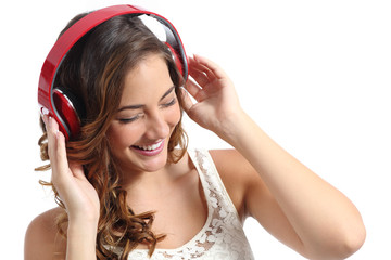 Happy woman enjoying listening to the music from headphones