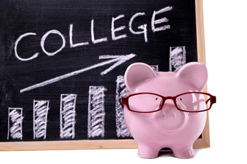 Piggy Bank or piggybank with college fund savings or fees chart written on smaill blackboard...