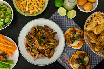 Sports feast - chicken wings, vegetable, french fries, pizza