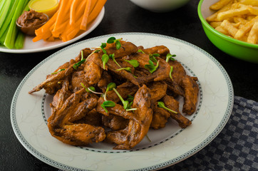 Sports feast - chicken wings, vegetable, french fries, pizza