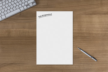 Blank sheet Development on a wooden table