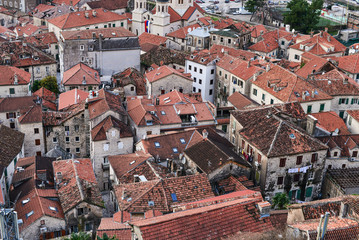 Fototapeta na wymiar The view over red tiles roofs of the old center of Kotor, Monten