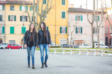 Female Twins Walking at City Public Square