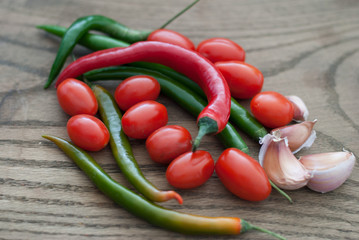 Red and Green Hot Peppers with Garlic Cloves and Grape Tomatos o
