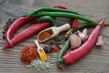 Red and Green Hot Peppers with Spices on Dark Wooden Background,