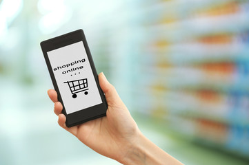 Mobile shopping concept. Hand holding mobile phone for internet