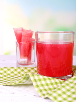 Watermelon cocktail in glass on table on natural background