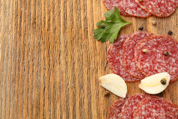 Slices of salami with cloves of garlic and spices