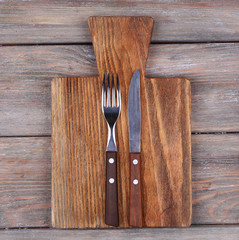Cutting board with fork and knife