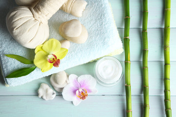 Spa treatments with orchid flowers on wooden table background