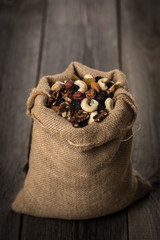 Bug filled with nuts standing on wooden background