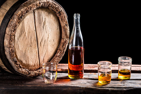 Three glass of aged whisky and bottle