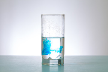 in glass of water soluble blue dye