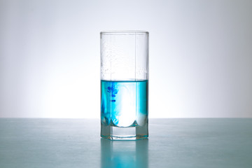 glass of blue water