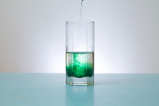 pours into glass green powder
