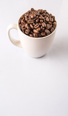 Roasted coffee bean in white mug