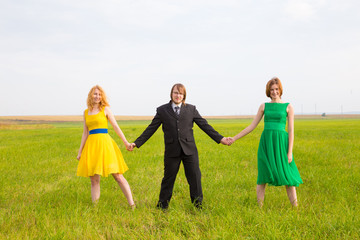 Naklejka premium two girls share one man in the field