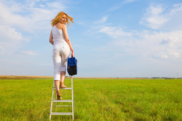 redhead girl with blue bag while standing on ladder