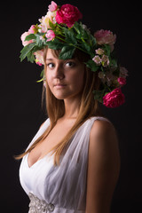 portrait of girl in  with  wreath of flowers on  head in studio