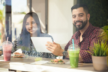 Happy couple using technology