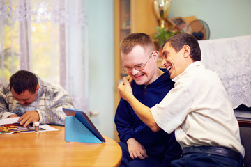 happy friends with disability socializing through internet - 78295544