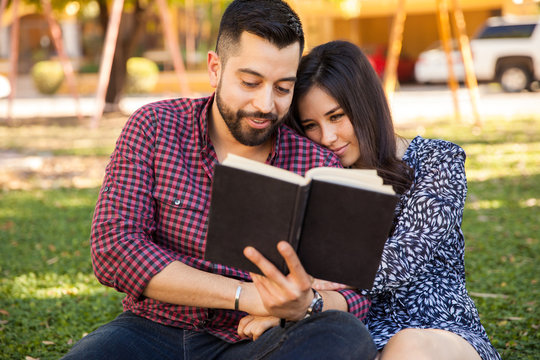 Couple reading outdoors
