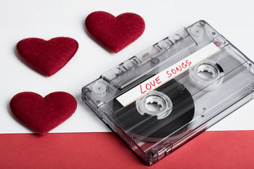 Audio cassette tape on red backgound with fabric heart