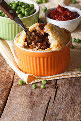 Tasty Australian meat pie in a pot on the table. vertical