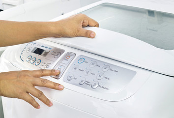 finger press button start on white washing machine